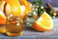 Bottle of orange essential oil with  orange slice, peel and leaf on wooden table Royalty Free Stock Photo