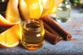 Bottle of orange essential oil with  orange slice, peel and leaf on wooden table Royalty Free Stock Photo