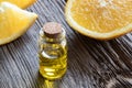 A bottle of orange essential oil on a wooden background Royalty Free Stock Photo