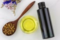 Bottle of organic cold pressed grapeseed oil and clear bowl with