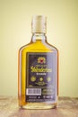 Bottle of original albanian brandy Skenderbeu on gradient background. Royalty Free Stock Photo