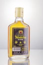 Bottle of original albanian brandy Skenderbeu on gradient background. Royalty Free Stock Photo