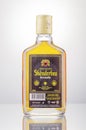 Bottle of original albanian brandy Skenderbeu on gradient background. Royalty Free Stock Photo