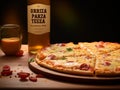 A bottle of Orrizia Parza Teea sits next to a pizza Royalty Free Stock Photo
