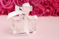 Bottle of parfum and rose flowers on pink background Royalty Free Stock Photo