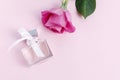 Bottle of parfum and rose flowers on pink background Royalty Free Stock Photo