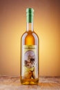 Bottle of pear flavored rakija isolated on gradient background produced in Omis, Croatia.