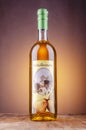 Bottle of pear flavored rakija isolated on gradient background produced in Omis, Croatia.