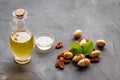 Bottle of pecan oil with nuts on the table, close up Royalty Free Stock Photo