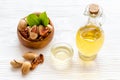 Bottle of pecan oil with nuts on the table, close up Royalty Free Stock Photo