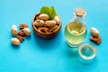 Bottle of pecan oil with nuts on the table, close up Royalty Free Stock Photo