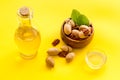 Bottle of pecan oil with nuts on the table, close up Royalty Free Stock Photo