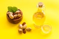Bottle of pecan oil with nuts on the table, close up Royalty Free Stock Photo