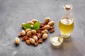 Bottle of pecan oil with nuts on the table, close up Royalty Free Stock Photo