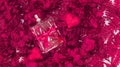 a bottle of perfm is tied with a gift ribbon next to red hearts on a background of hydrangea flowers and fern leaves