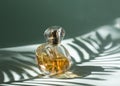 A bottle of perfume and cosmetics. On a green background with a palm tree branch. The play of light and shadow