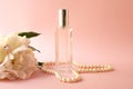 Bottle of perfume with flower on pink background Royalty Free Stock Photo