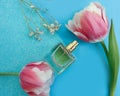 Bottle perfume flower tulip on colored background