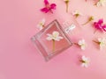 Bottle with perfume, flowers beautiful on a colored background