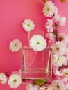 Bottle with perfume, flowers romantic on a colored background