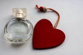 Bottle of perfume with red hearts flying out from it. Valentine`s day, choosing fragrance, pheromones Royalty Free Stock Photo