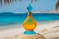 A bottle of perfume on the seashore is enveloped in a wave. Yellow sand on the beach, marine cosmetics and fragrance Royalty Free Stock Photo