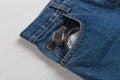 Bottle of perfume or toilet water in a pocket of blue jeans