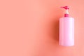 Bottle with pink dishwashing liquid on pink background. Minimal concept Royalty Free Stock Photo