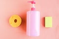 Bottle with pink dishwashing liquid on pink background. Royalty Free Stock Photo