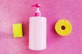 Bottle with pink dishwashing liquid on pink glitter background. Royalty Free Stock Photo