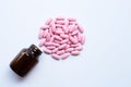 Bottle with pink medicine pills