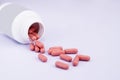 Bottle with pink pills on a light background Royalty Free Stock Photo