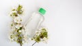 Bottle placed for mock up  on white background and flowers. The concept of natural beauty products Royalty Free Stock Photo
