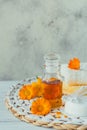 A bottle of pot marigold tincture or infusion with fresh calendula flowers and cotton pad and sticks on a white background. Royalty Free Stock Photo