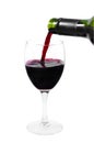 A bottle pouring red wine into a clear glass Royalty Free Stock Photo
