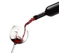 Bottle pouring red wine in glass with splashes Royalty Free Stock Photo