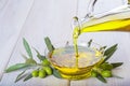 Bottle pouring virgin extra olive oil in a bowl Royalty Free Stock Photo