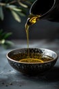 Bottle pouring virgin olive oil in a bowl