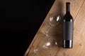 A bottle of red expensive wine with a black blank label on a dark background with a glass. Wine bottle mockup with space for text Royalty Free Stock Photo