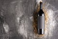 Bottle of red wine with black blank label on black texture. Mock up a bottle of wine. View from above. Flat lay. Black space Royalty Free Stock Photo