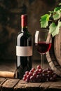 A bottle of red wine with a blank white label, a glass filled with red wine. A bunch of ripe purple grapes on the wooden surface Royalty Free Stock Photo