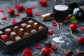 Bottle of red wine with box of chocolate candies on dark grey background Royalty Free Stock Photo