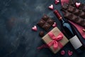 Bottle of red wine with box of chocolate candies on dark grey background Royalty Free Stock Photo
