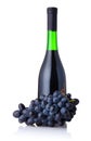 Bottle of red wine with bunch of grapes isolated