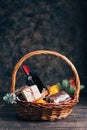 Bottle of red wine in Christmas gift basket. Royalty Free Stock Photo