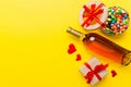 Bottle of red wine on colored background for Valentine Day with gift and chocolate. Heart shaped with gift box of Royalty Free Stock Photo