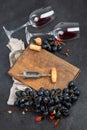 Bottle of red wine with a corkscrew. On a dark background Royalty Free Stock Photo