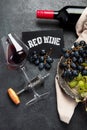 Bottle of red wine with a corkscrew. On a dark background Royalty Free Stock Photo