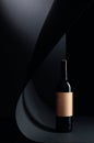 Bottle of red wine with empty paper label on a black background Royalty Free Stock Photo