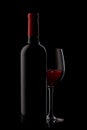 Bottle with red wine and glass on a black Royalty Free Stock Photo